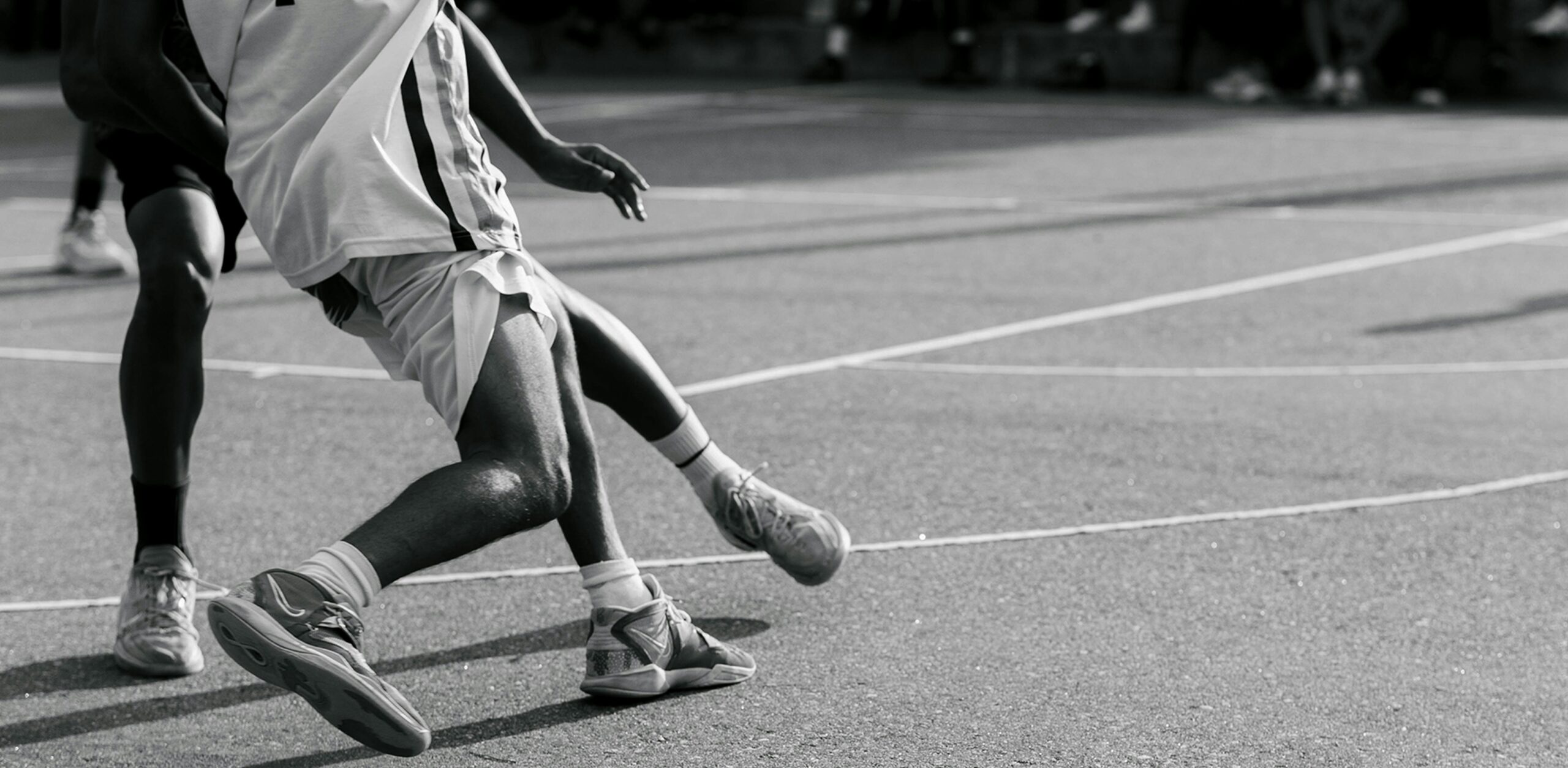 Black and white photo of two men playing basketball