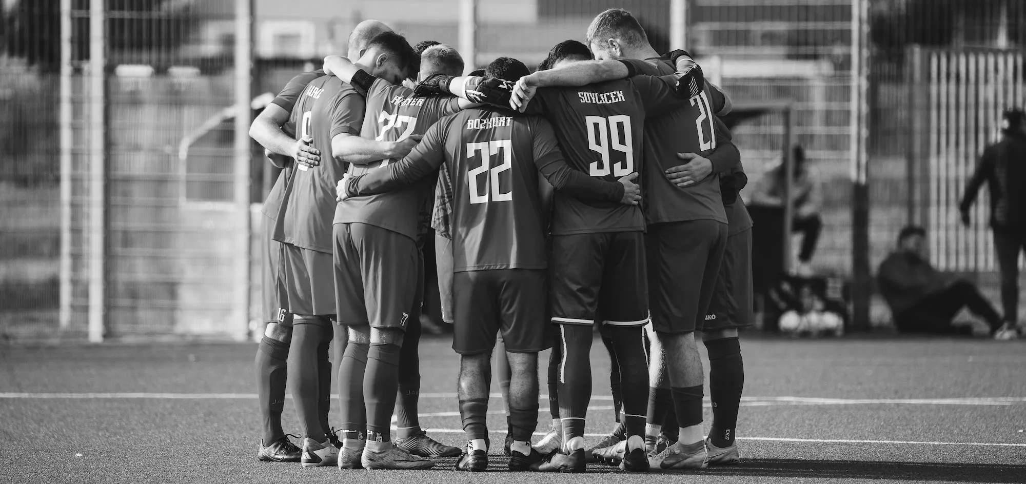 Soccer team huddled together in a team talk