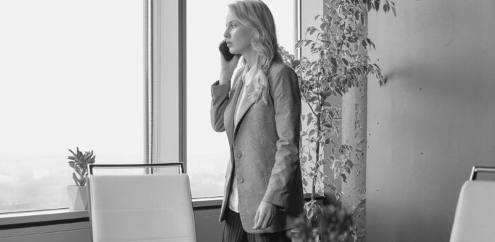 Concerned woman talking on the phone in her office